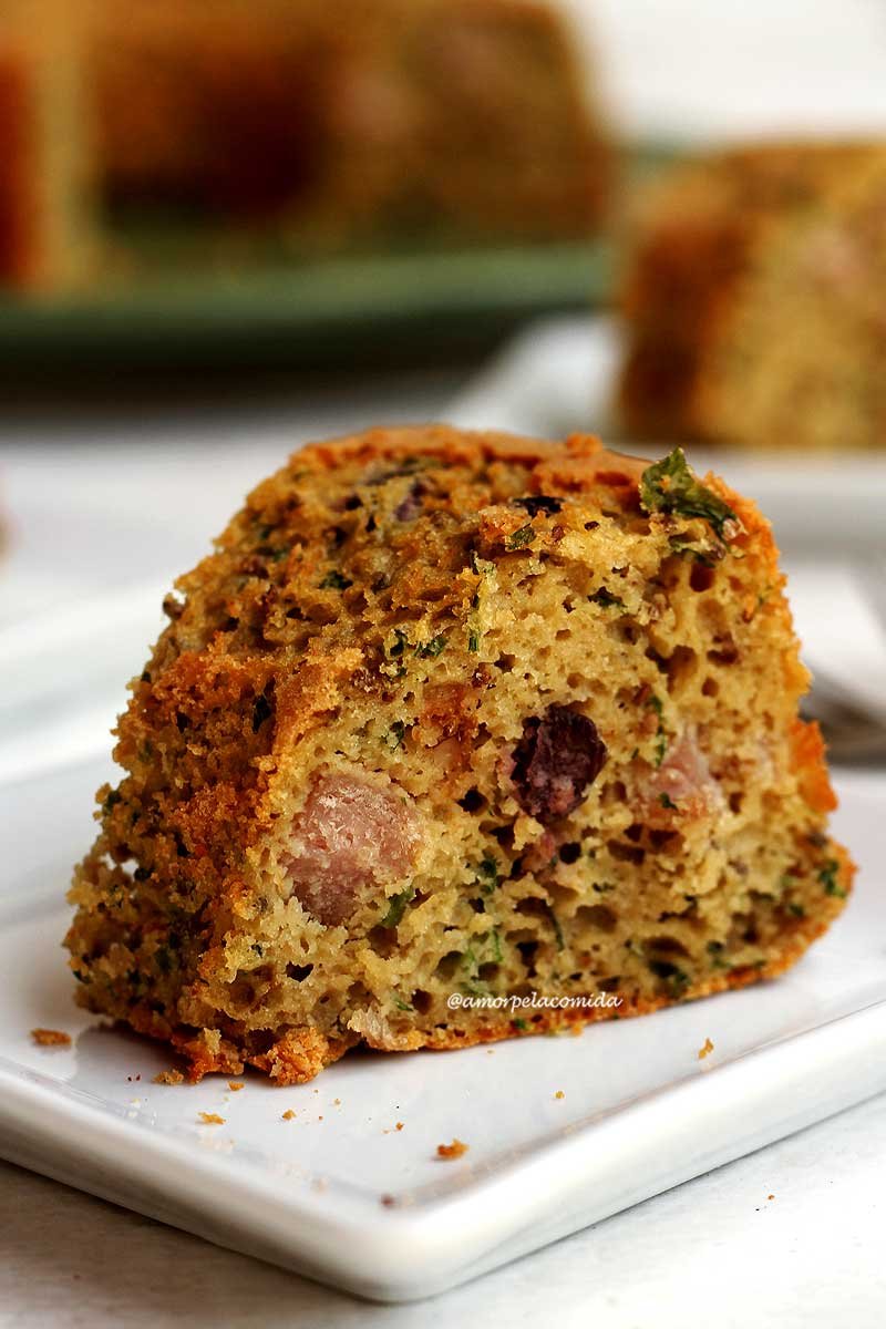 Slice of savory sweet potato cake on white square plate on white table