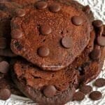 Várias panquecas de chocolate amontoadas sobre prato branco, sobre as panquecas gotinhas de chocolate para enfeitar